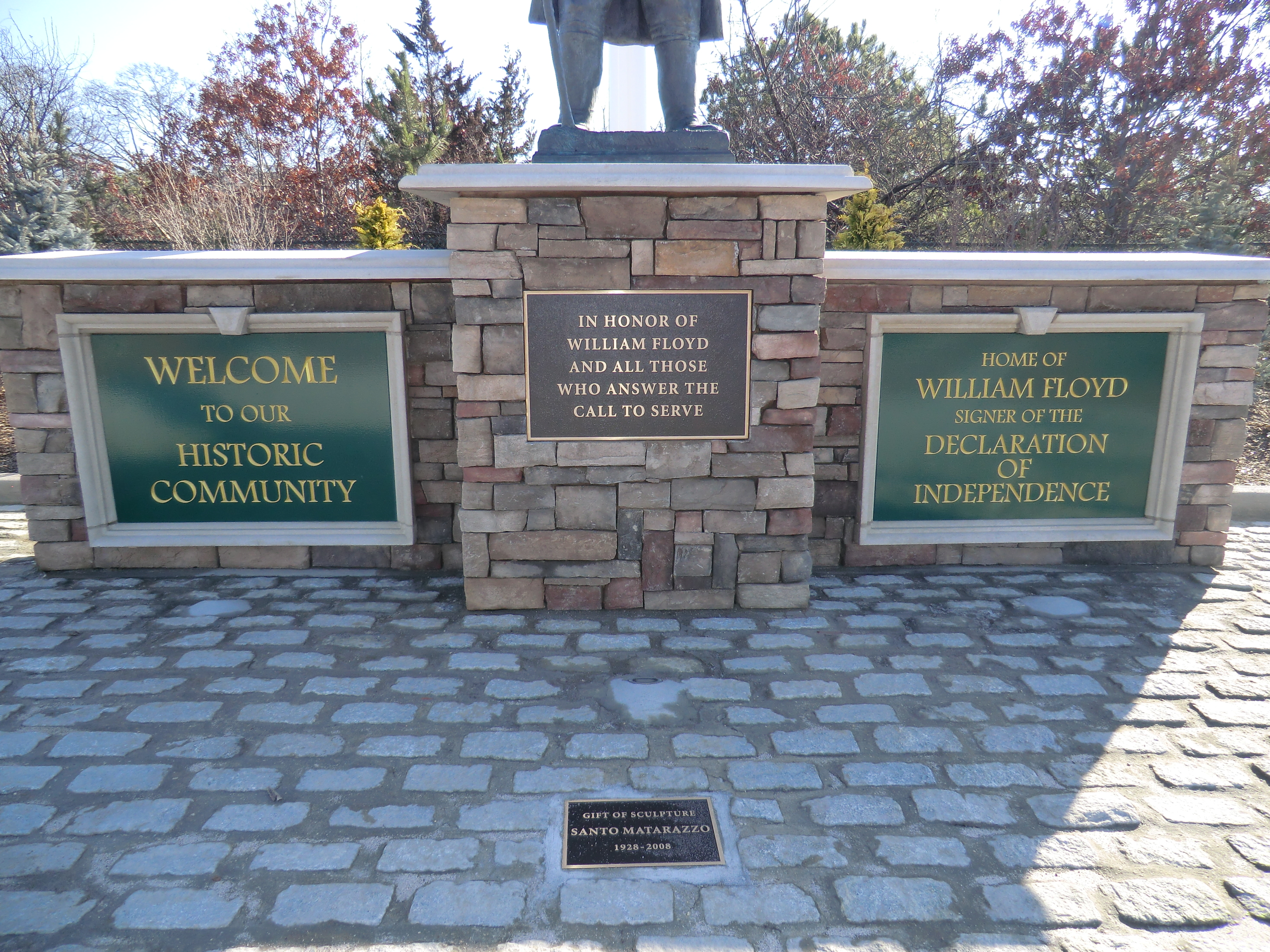 closeup of plaques at the foot of statue